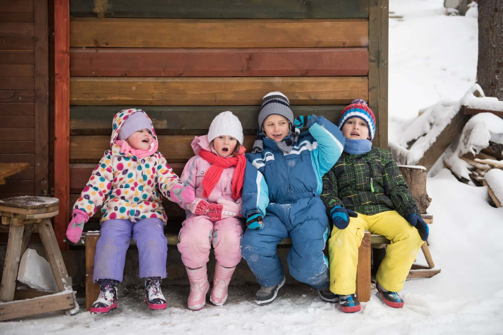 Kids enjoying winter fun in colorful thermal wear, perfect for outdoor activities like camping and travel.