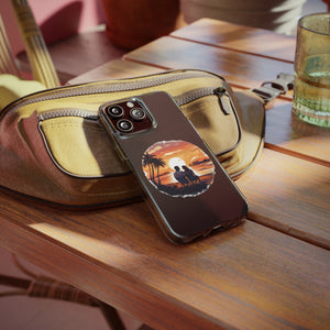 Phone case featuring sunset and palm trees on a table next to a bag, perfect for outdoor adventure lovers.