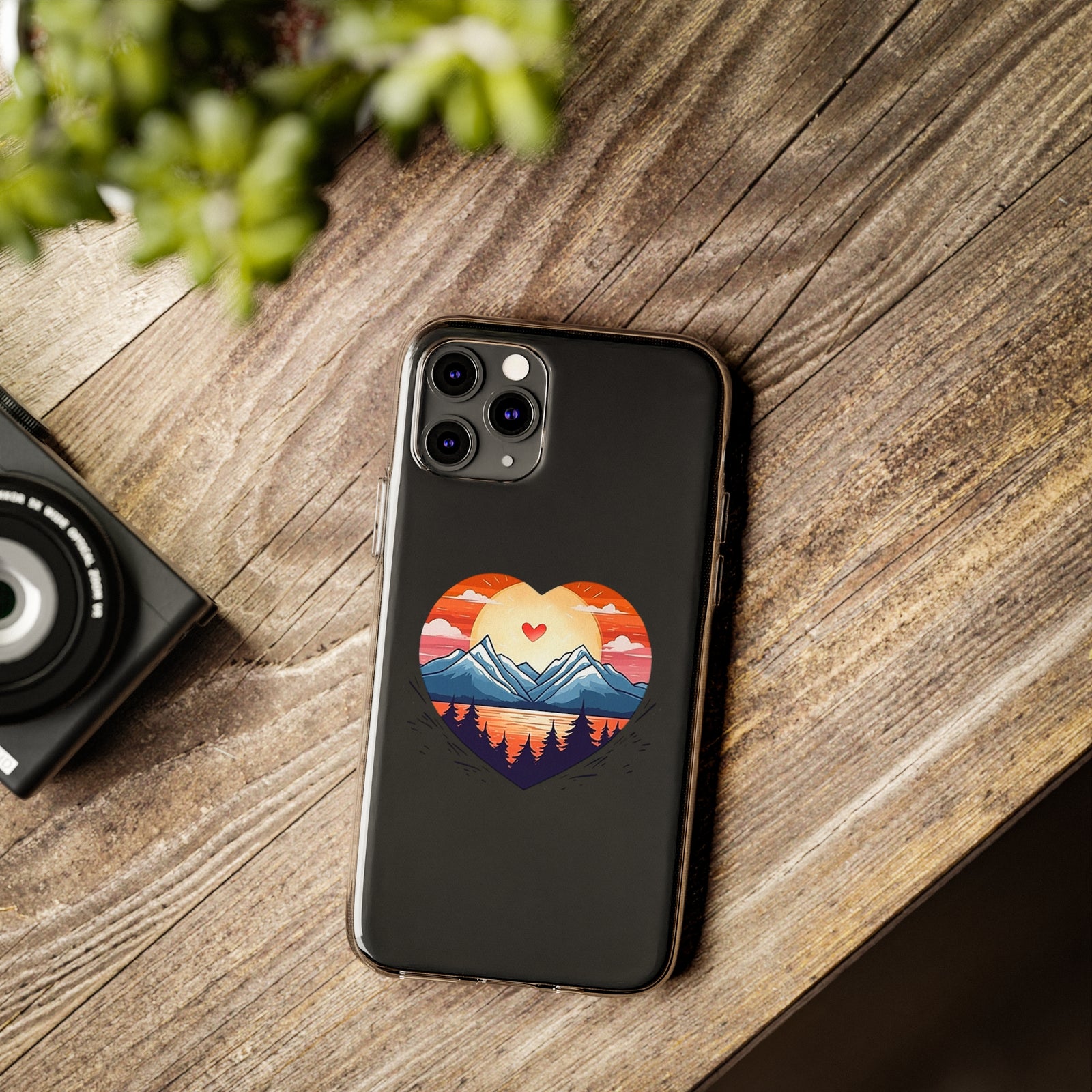 Phone case with mountain love design on wooden table, perfect for adventure and camping enthusiasts at revlando.com.
