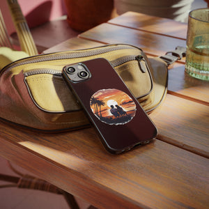 Soft phone case with sunset design on a table, perfect for outdoor adventures and camping, available at revlando.com.