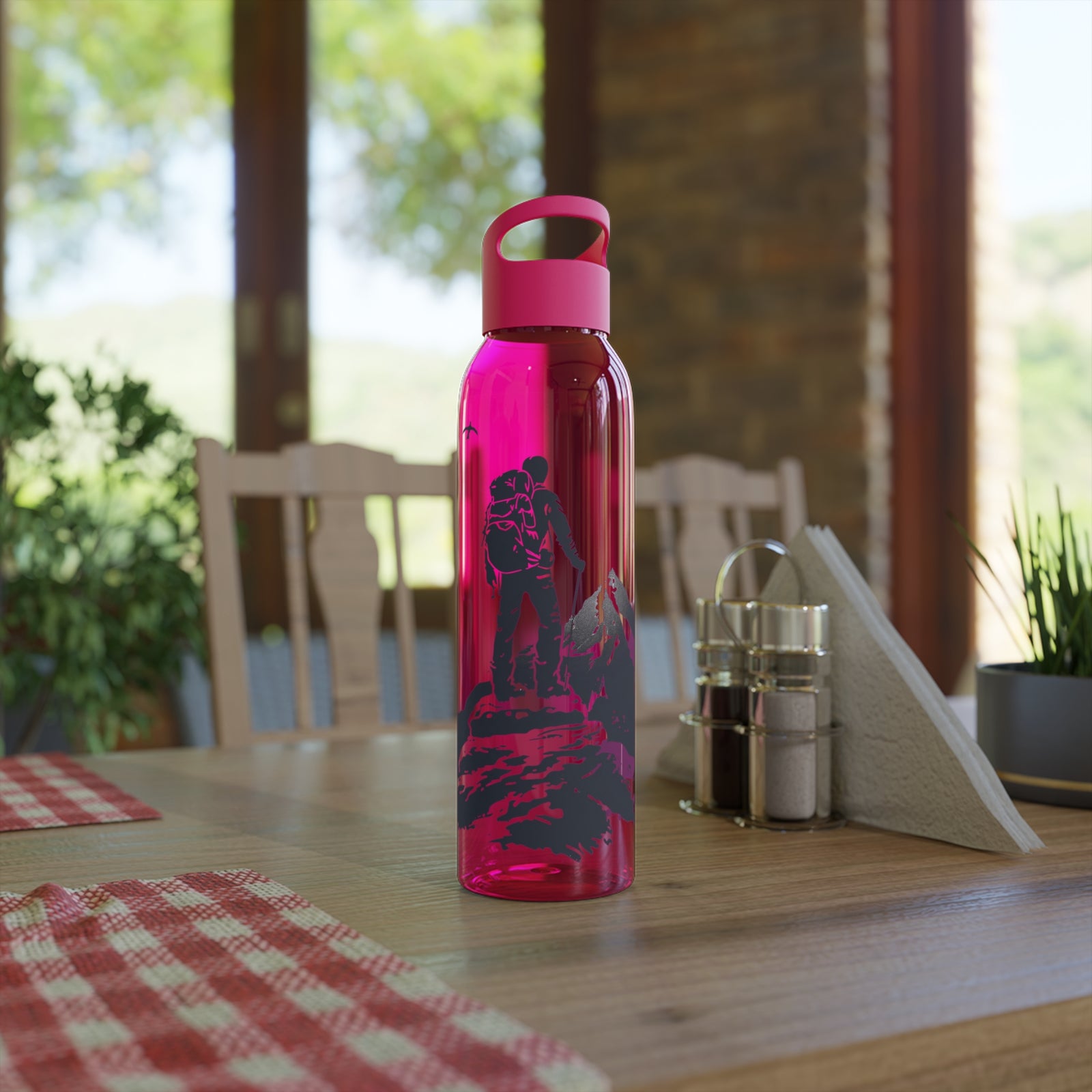 Stylish pink Sky Water Bottle on a dining table, perfect for outdoor adventures and camping, from revlando.com.