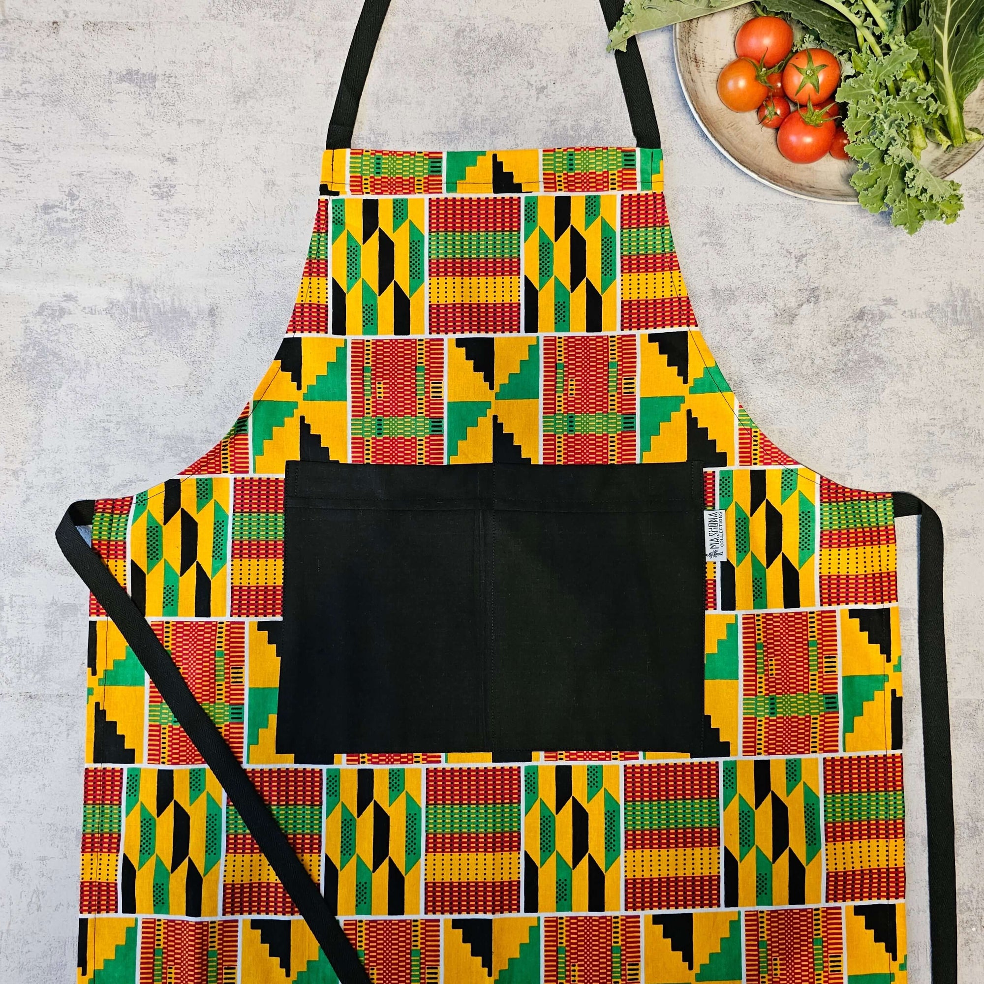 Handmade Kente print apron featuring a pocket, ideal for outdoor cooking and camping adventures.