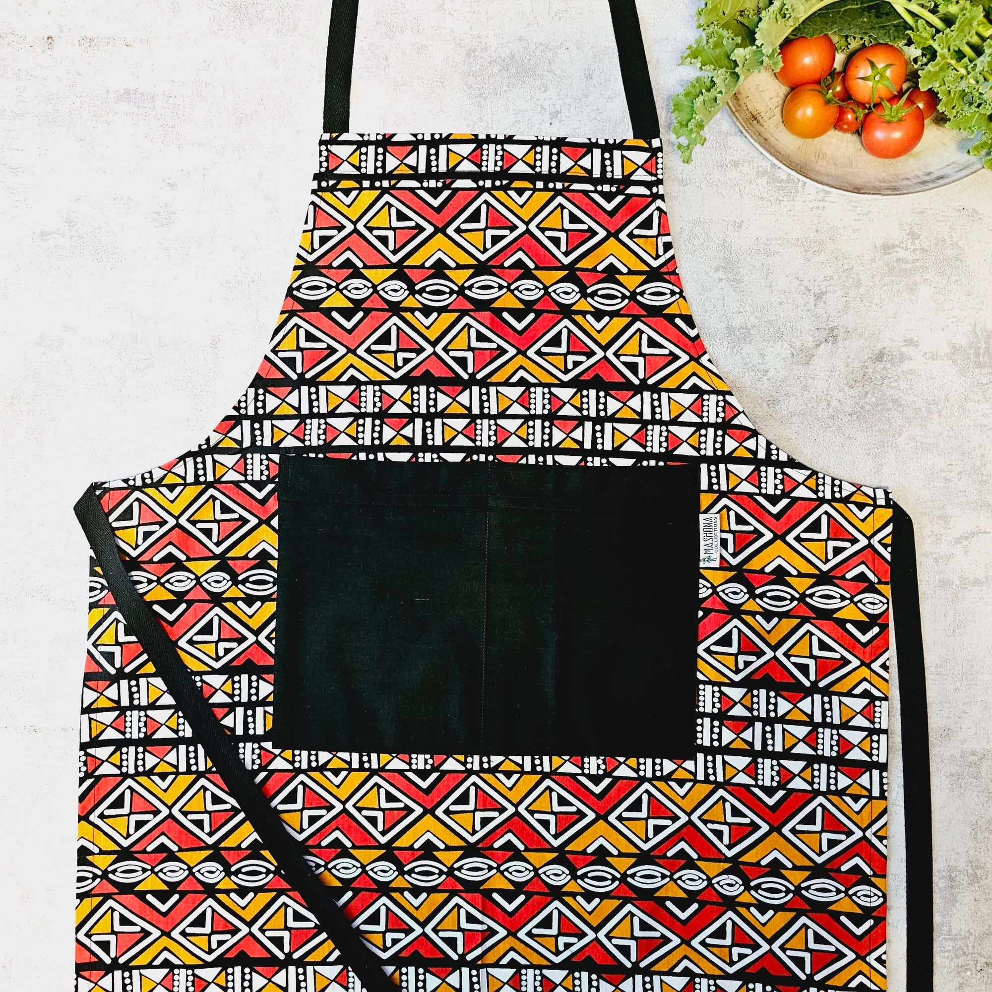 Handmade African print apron with pocket, vibrant colors, perfect for outdoor cooking adventures, revlando.com