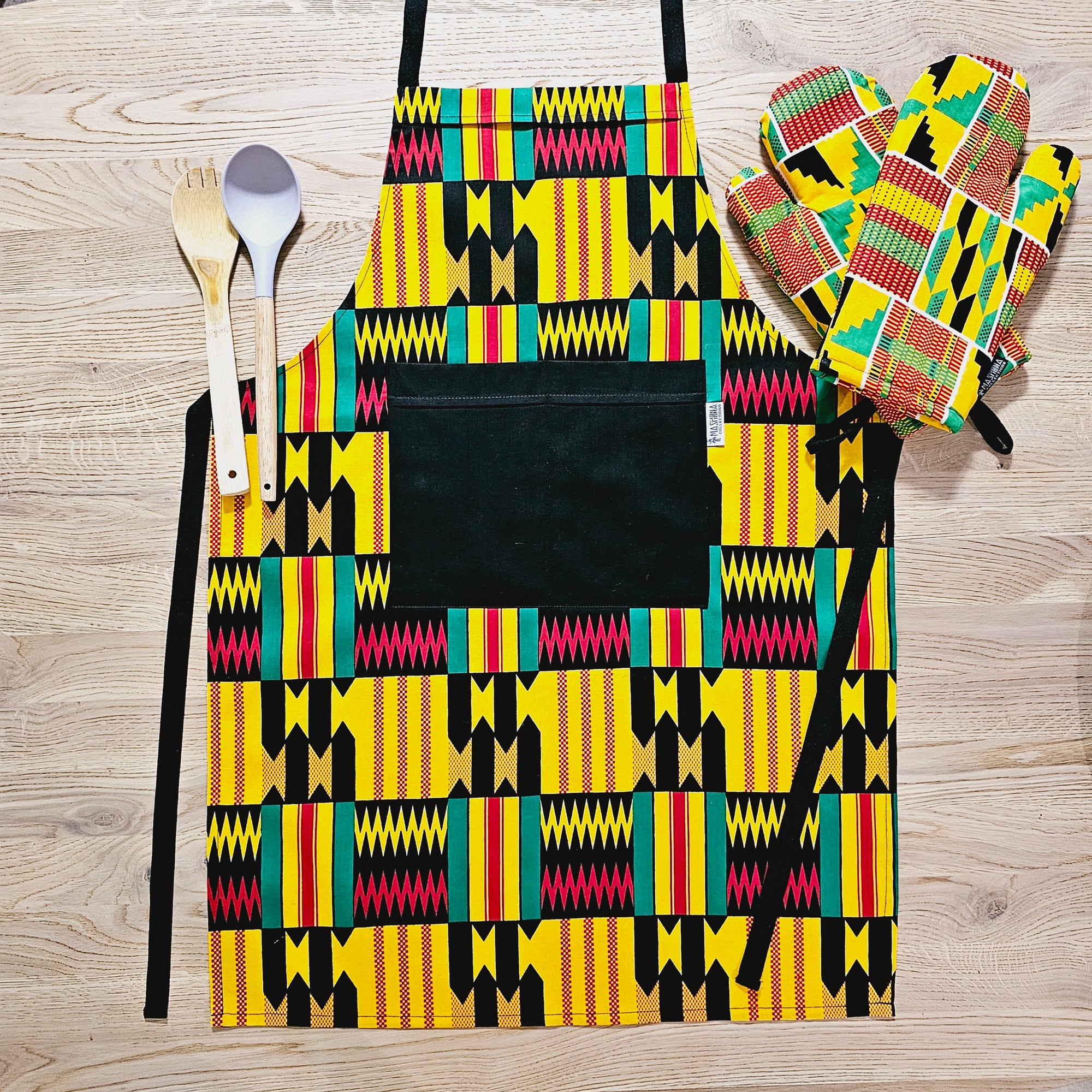 Handmade African print apron with pocket and matching oven gloves set, crafted from durable cotton, perfect for outdoor cooking.