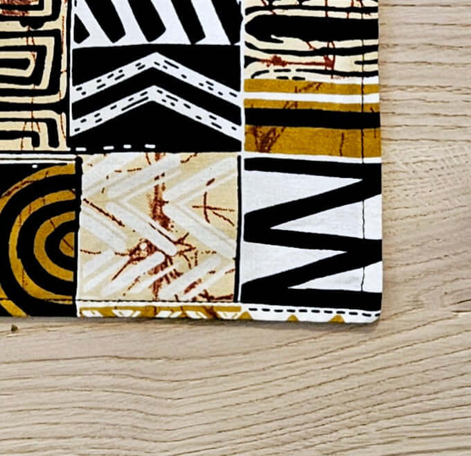 Handmade bohemian-inspired cotton placemat with African print, perfect for outdoor dining or camping adventures.