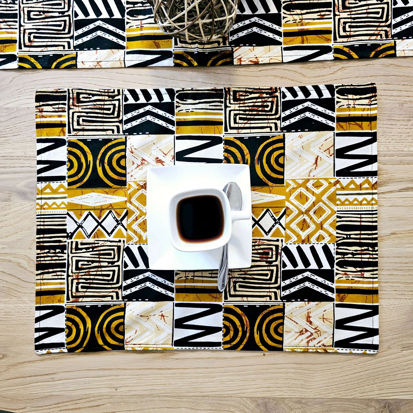 Handmade bohemian-inspired cotton placemat with African print, perfect for outdoor dining or camping adventures.