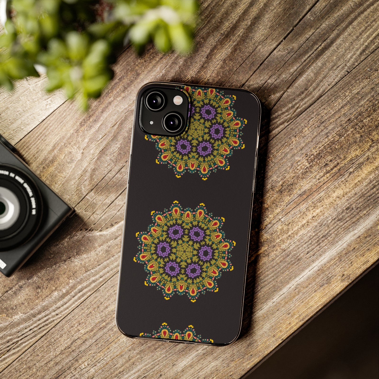 Gold Mandala phone case displayed on wooden table, perfect for outdoor adventures and camping. Available at revlando.com.
