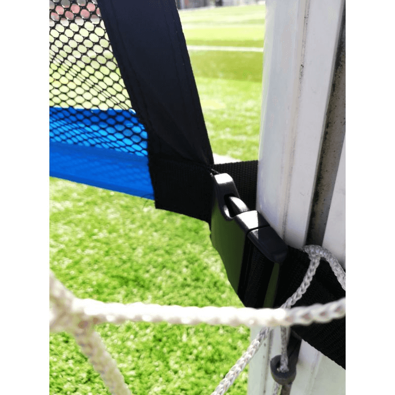 Close-up of the Yakima 100224 Shot Accuracy Mat attachment, showing secure fastening on a green outdoor field.