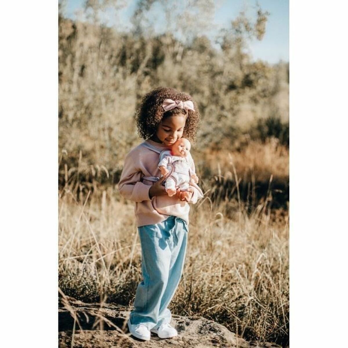 Baby Nurse baby carrier in pink with heart patterns, perfect for comfy outings and adventures with little ones.