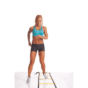 Woman performing agility drills on Power BB 2403 Speed Training Ladder for enhanced speed and coordination.