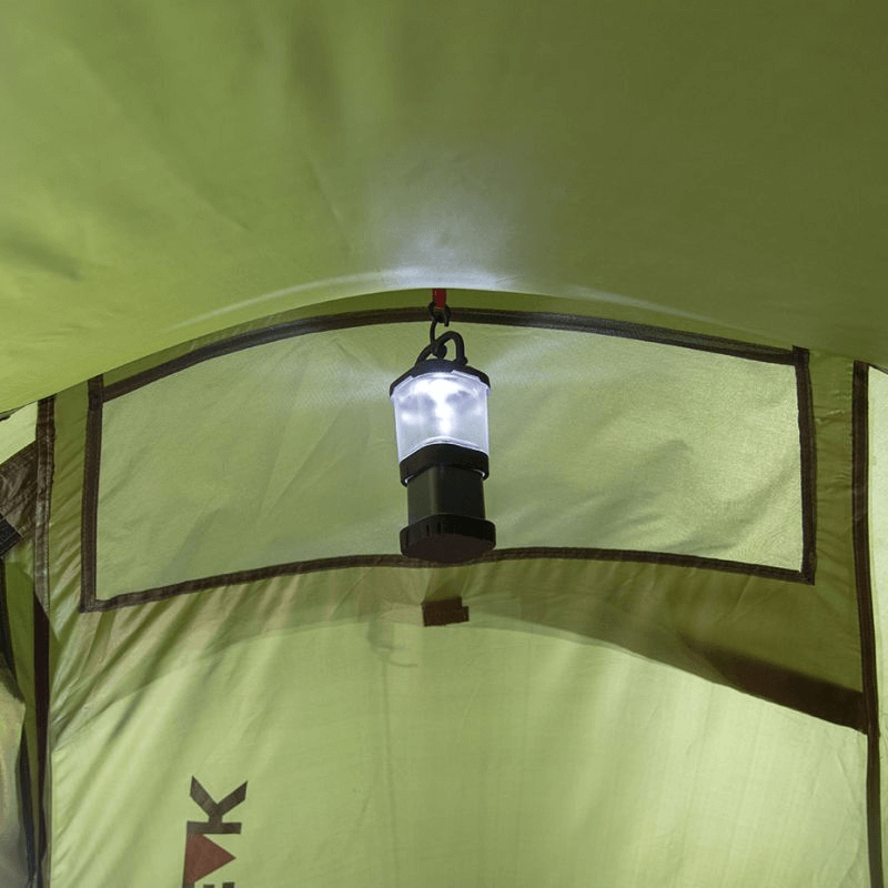 Interior view of High Peak Siskin 2 Tent with hanging lantern, showcasing outdoor adventure functionality and comfort.