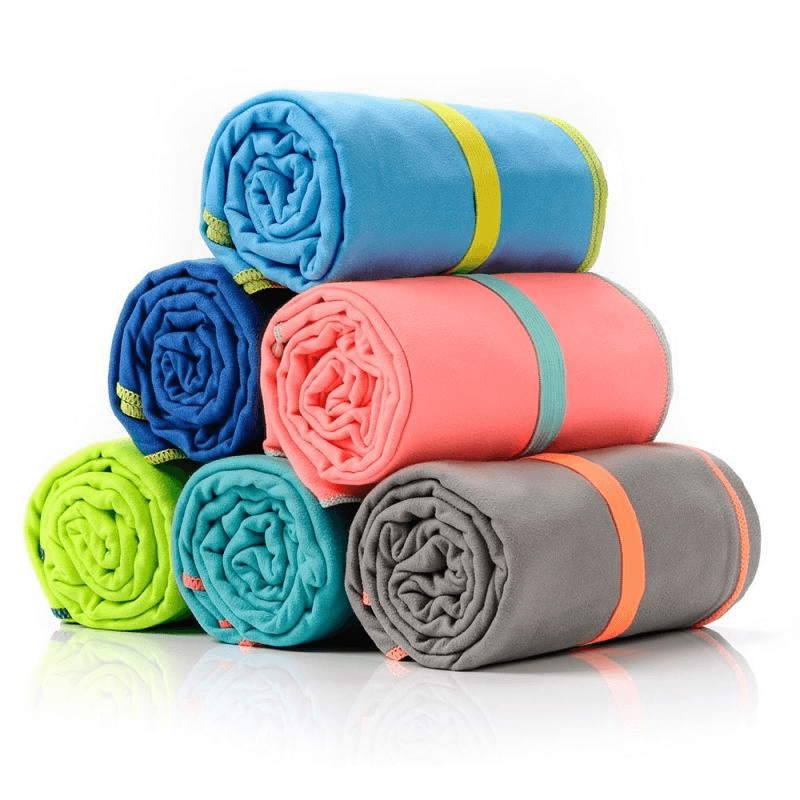 Stack of colorful Meteor microfiber towels, ideal for outdoor activities, travel, and gym use, featuring durable and quick-drying fabric.