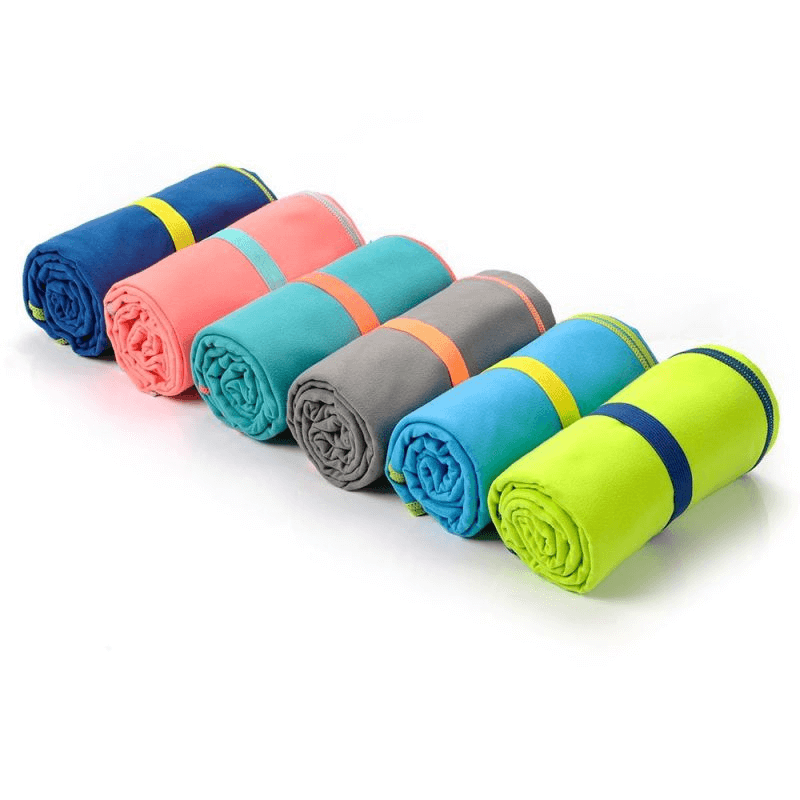 Rolled Meteor Navy Microfiber Towels in vibrant colors, perfect for outdoor adventures, sports, and travel.