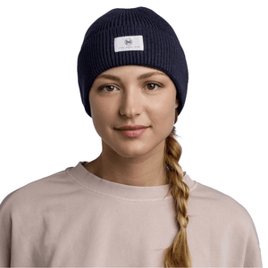 Buff Drisk Navy Knitted Beanie worn by a woman, showcasing stylish outdoor winter headwear for comfort and adventure.