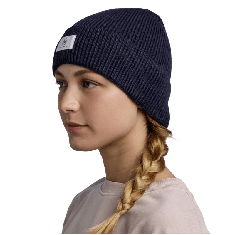 Woman wearing a navy Buff Drisk Knitted Hat Beanie, showcasing stylish and warm winter headwear for outdoor adventures.