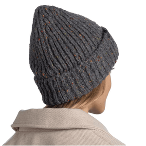 Woman wearing Buff Kim Knitted Fleece Hat Beanie in gray, showcasing stylish design for outdoor winter activities.