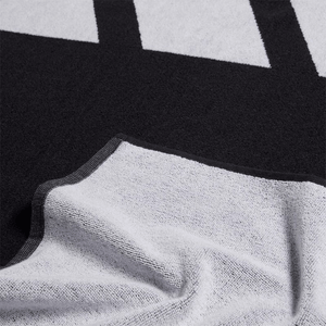 Close-up of Adidas 3BAR L Towel in black and white, showcasing soft cotton texture and design ideal for sports and outdoor use.