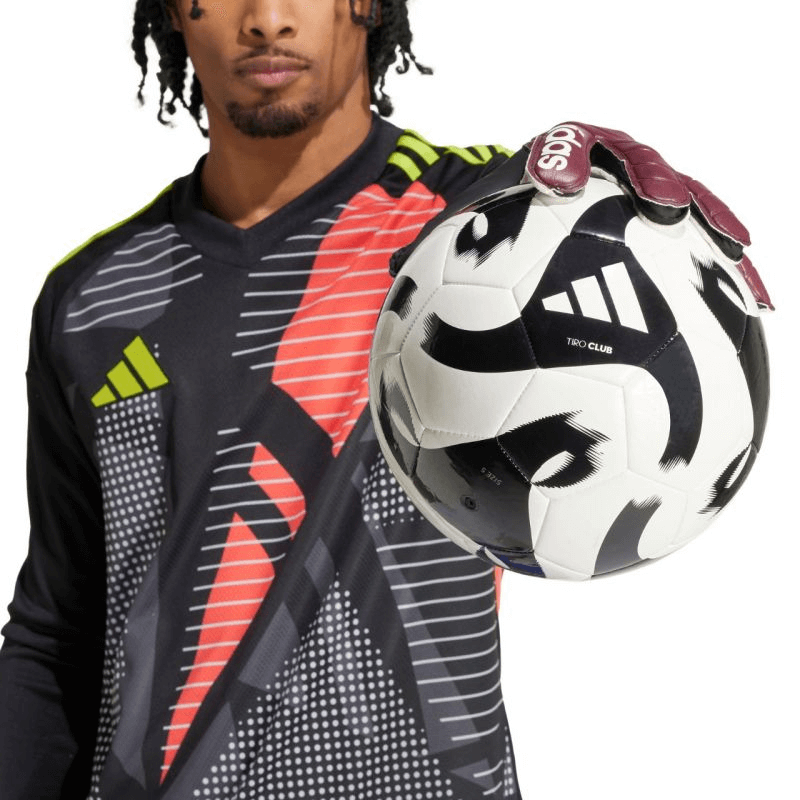 Male goalkeeper wearing Adidas Copa Club gloves, holding a soccer ball, showcasing outdoor sports performance.