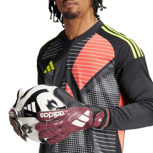 Male goalkeeper wearing Adidas Copa Club gloves, holding a soccer ball, showcasing premium performance for sports and outdoor adventures.