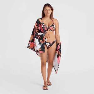 Woman in floral bikini holding O'Neill Seacoast towel, perfect for outdoor adventures and travel.