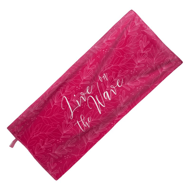 Aquawave Rannas Towel in pink with "Live on the Wave" design, perfect for outdoor travel and beach adventures.