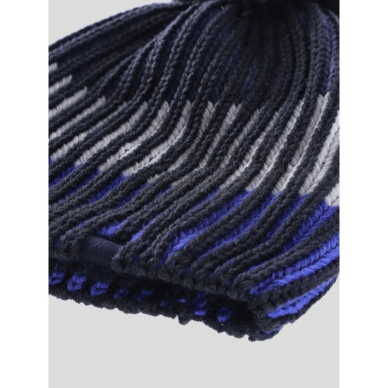 Cozy boys' winter hat with pompom in navy and gray stripes, perfect for outdoor adventures and sports.