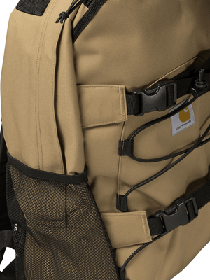 Side view of CARHARTT WIP lightweight men's backpack in tobacco brown, featuring adjustable straps and mesh pocket.