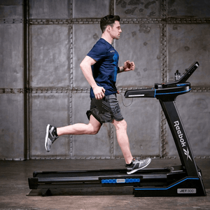 man running on the Reebok JET 300 treadmill, showcasing advanced Air Motion Technology in a fitness setting