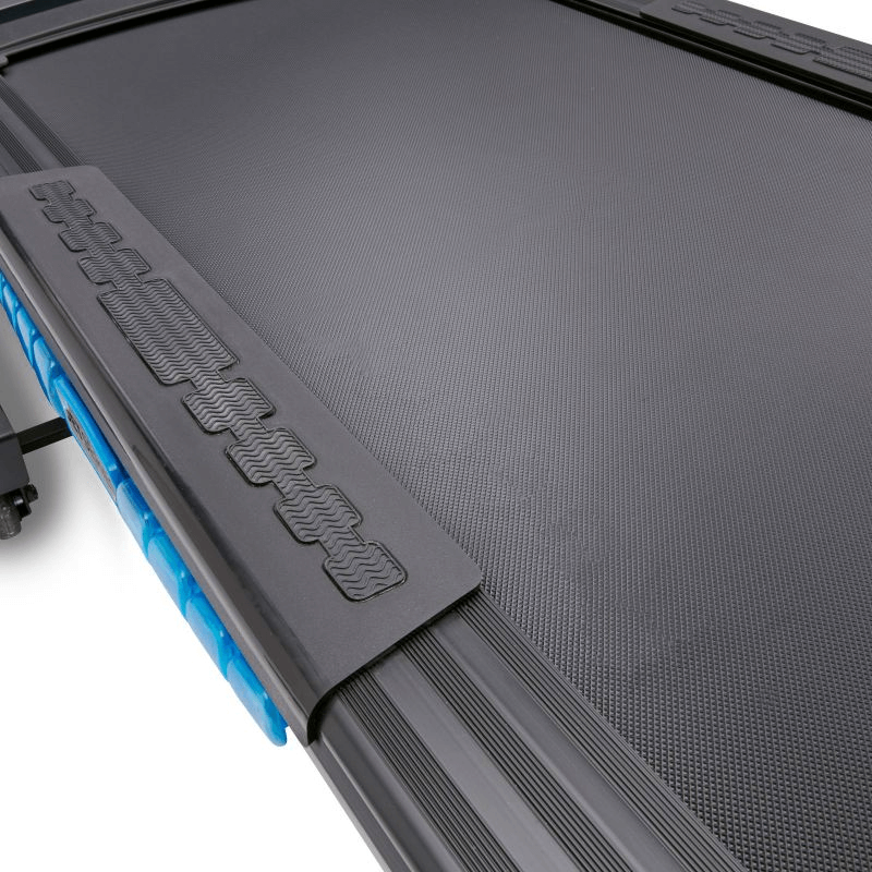 Close-up of the textured running surface of the Reebok JET 300 treadmill, showcasing durability and grip for outdoor sports training.