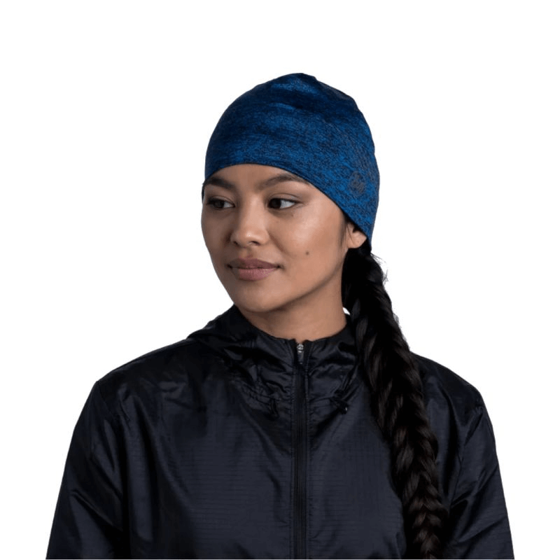 Buff Dryflx Beanie in navy, perfect for outdoor sports and training, worn by a woman with a braid in a black jacket.