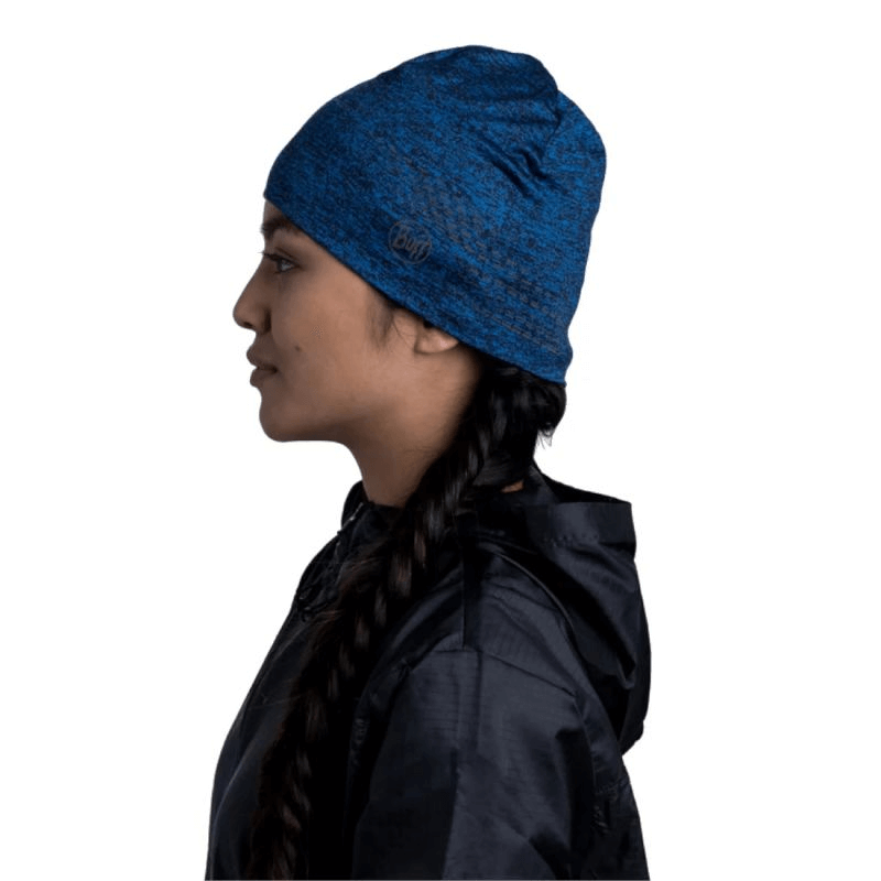 Buff Dryflx Beanie in Navy worn by a woman, showcasing its lightweight design for outdoor sports and adventures.