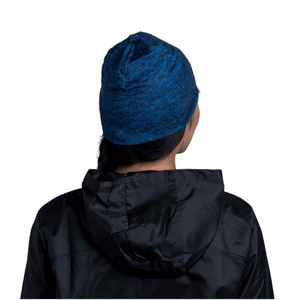 Back view of a person wearing a navy Buff Dryflx beanie with a black jacket, perfect for outdoor training and adventures.