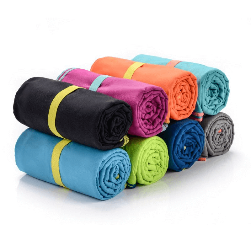 Rolled microfiber towels in various colors, perfect for outdoor sports, travel, and adventures, showcasing lightweight design.