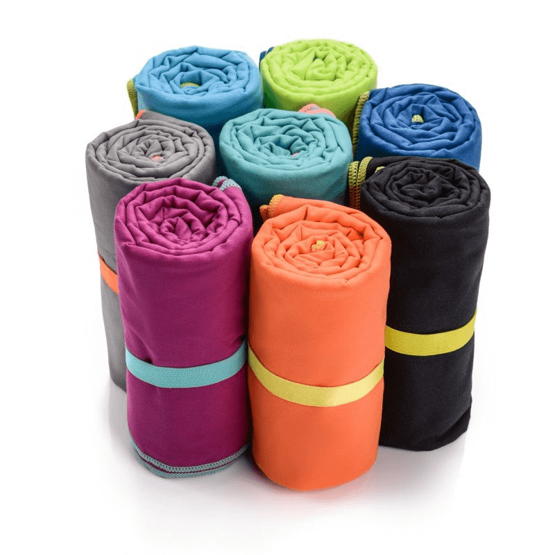 Assorted rolled microfiber towels in vibrant colors, ideal for outdoor adventures, travel, and sports activities.