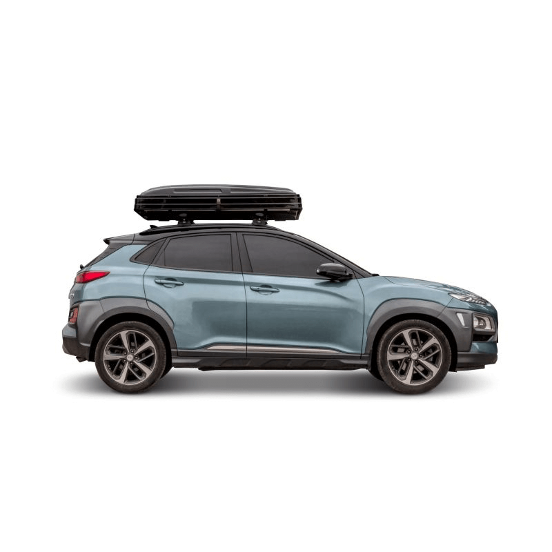 Side view of a blue SUV with a black roof tent, perfect for outdoor adventures and travel.