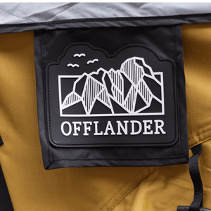 Offlander logo featuring mountains on a yellow and black background, symbolizing adventure and outdoor exploration.