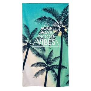 Aquawave towel with palm tree design, displaying "Good Vibes," perfect for outdoor adventures and travel.