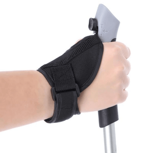 Close-up of a hand gripping an ergonomic Nordic walking pole with an adjustable wrist strap for comfort and support.