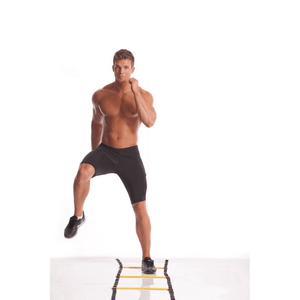 Man performing agility drills on Power BB 2403 Speed Training Ladder for enhanced speed and coordination during outdoor sports.