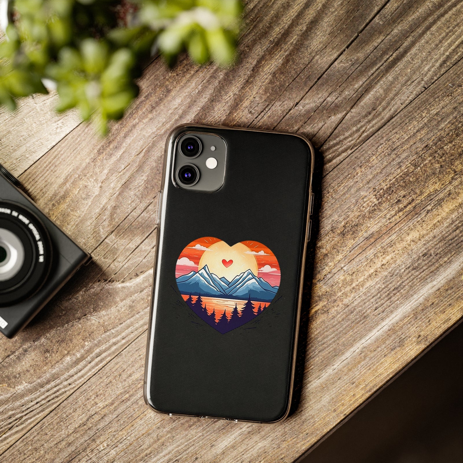 Stylish mountain love phone case on wooden table, perfect for outdoor adventures and camping, available at revlando.com.