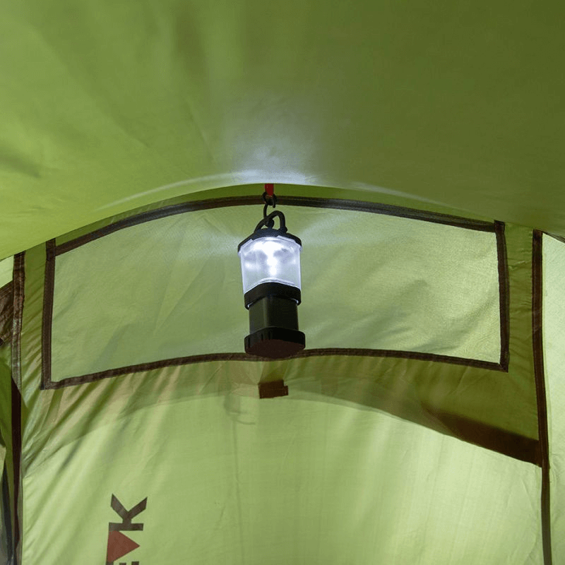 Interior view of High Peak tent with a hanging lantern illuminating the space for camping adventures.