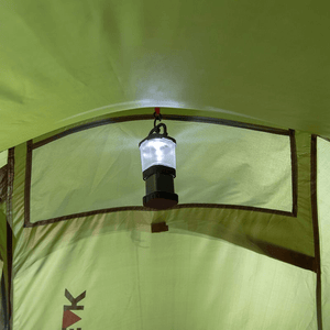 Interior view of High Peak tent with a hanging lantern illuminating the space for camping adventures.