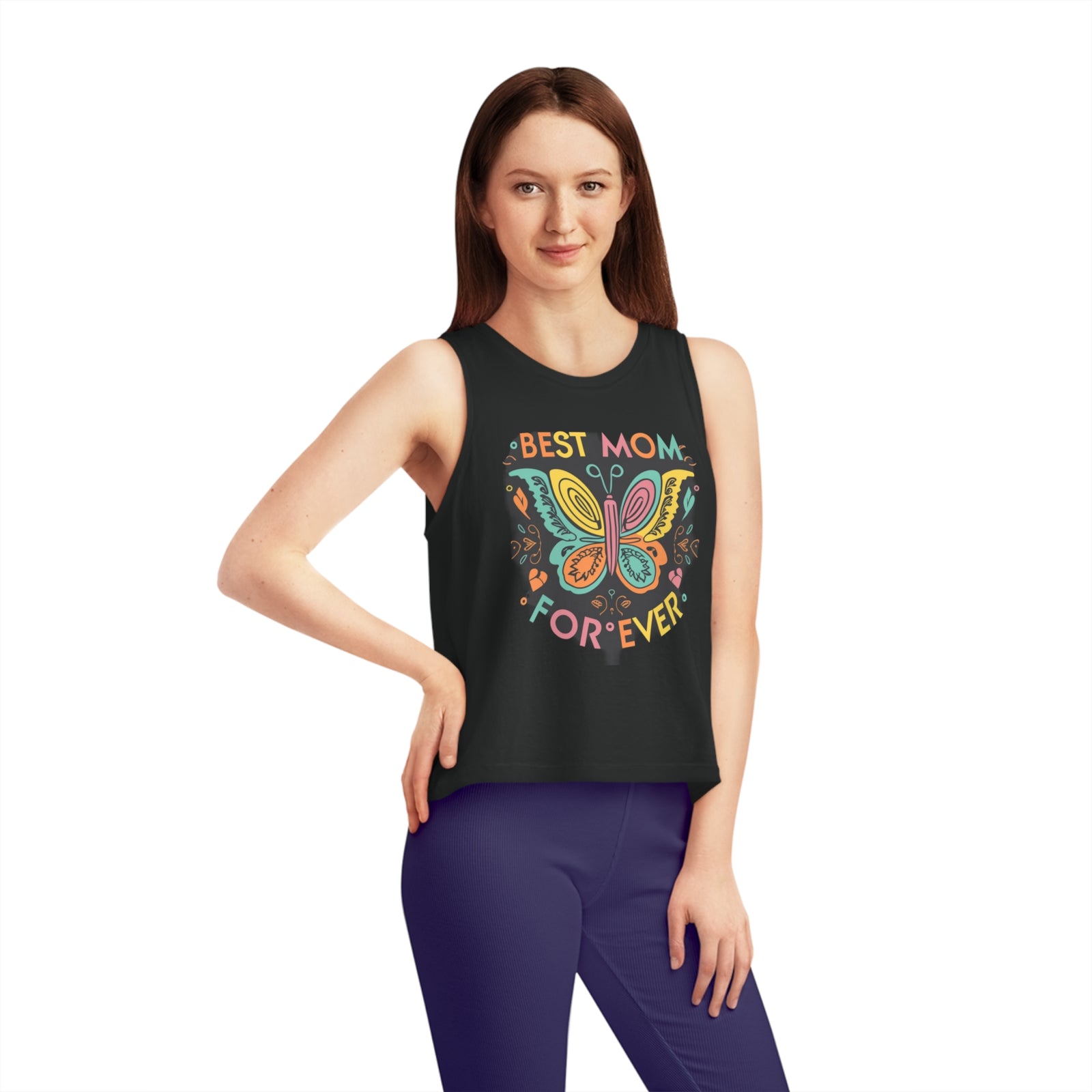 Woman wearing a cropped tank top featuring 'Best Mom Forever' and butterfly design, perfect for outdoor adventures.