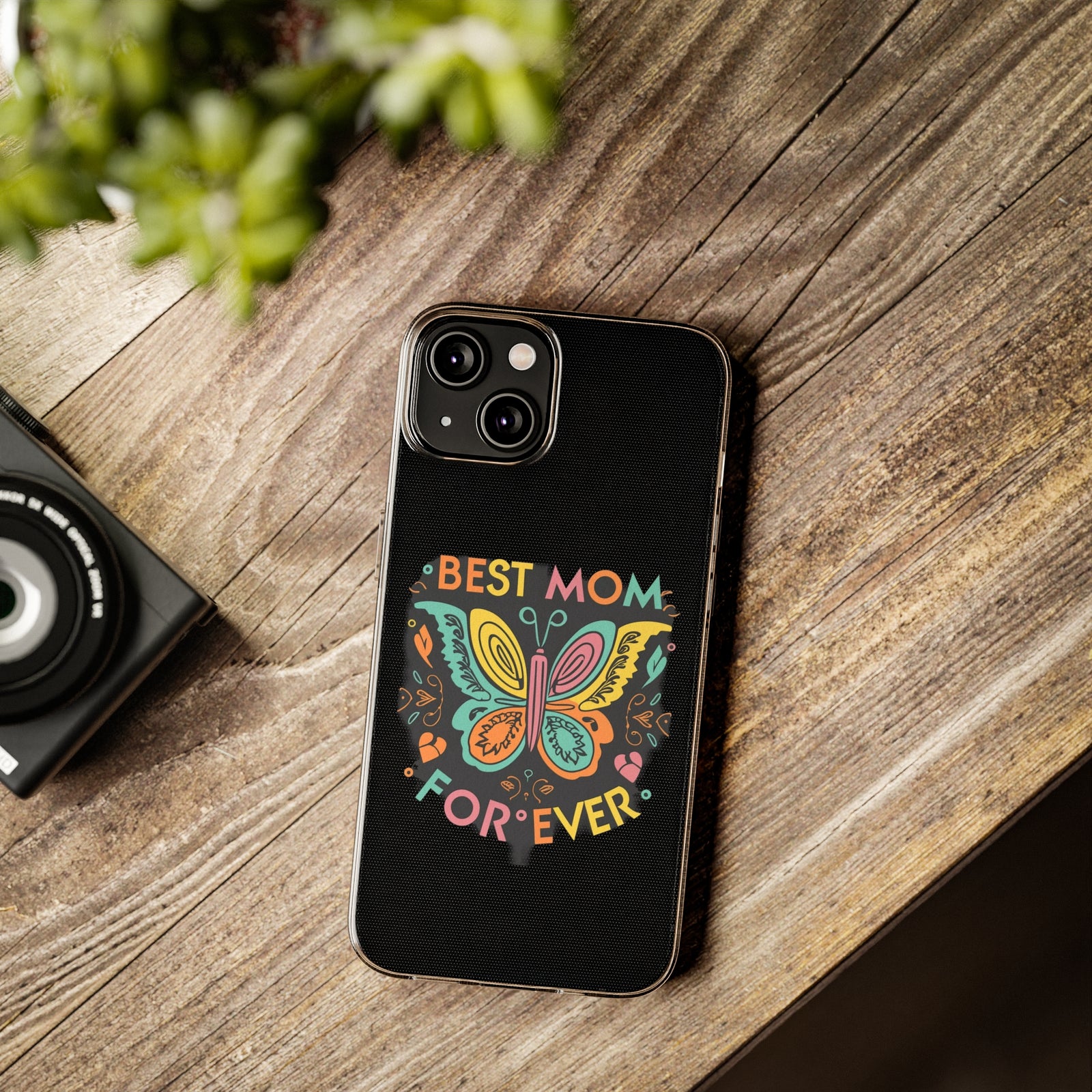 Colorful phone case with 'Best Mom Forever' design on wooden table, perfect for outdoor adventures and camping.