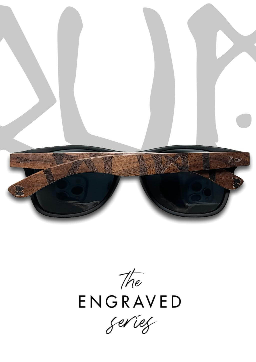 Hand holding Eyewood engraved wooden sunglasses featuring Viking runes outdoors, ideal for adventure and camping.