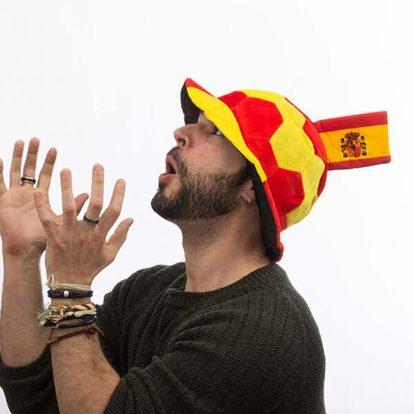 Man wearing a red and yellow football hat with Spanish flag, perfect for outdoor adventures and cheering on your team.