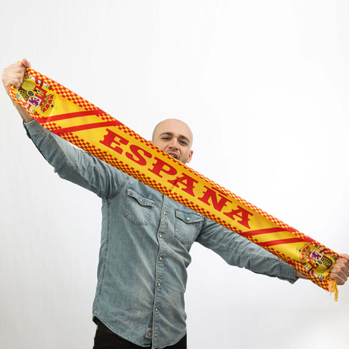 Man proudly displaying a vibrant Spanish scarf, ideal for outdoor adventures and camping, available at revlando.com.