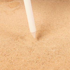 Beach tent peg being inserted into sandy ground for outdoor camping adventures at revlando.com.