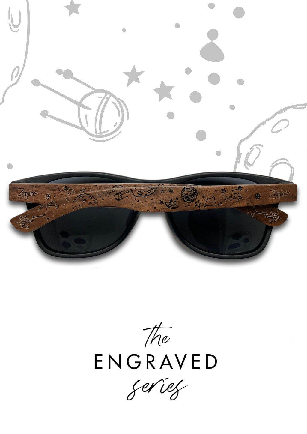 Person holding engraved wooden sunglasses with intricate designs, showcasing outdoor adventure style.