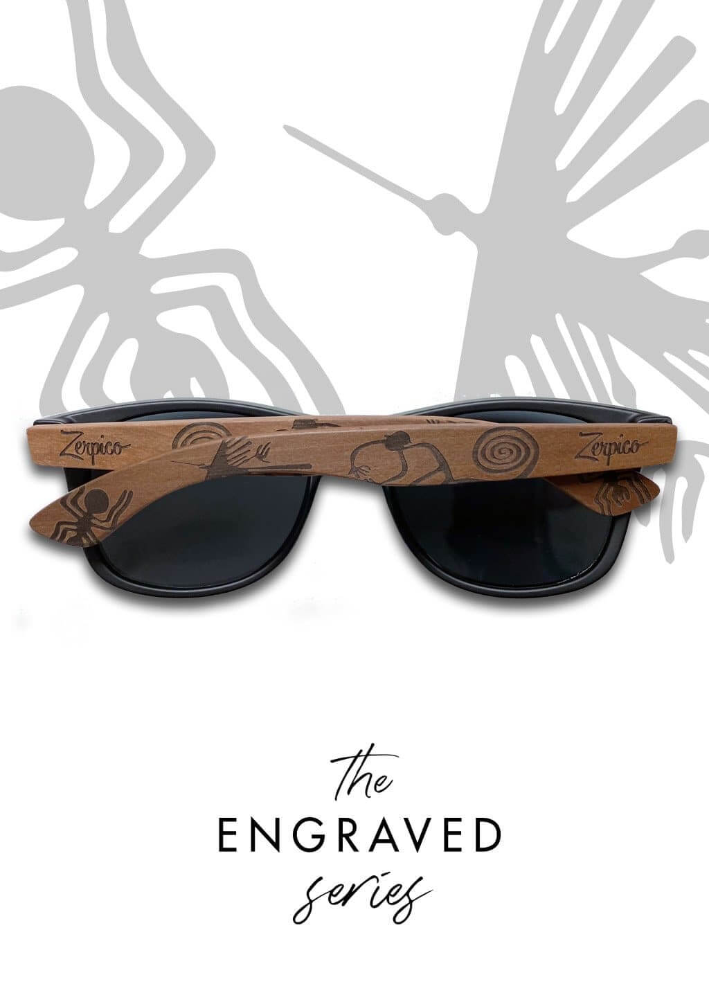 Handmade wooden sunglasses with engraved temples resting on tree branches, perfect for outdoor adventures.
